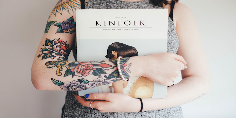 tattooed-girl-holding-book